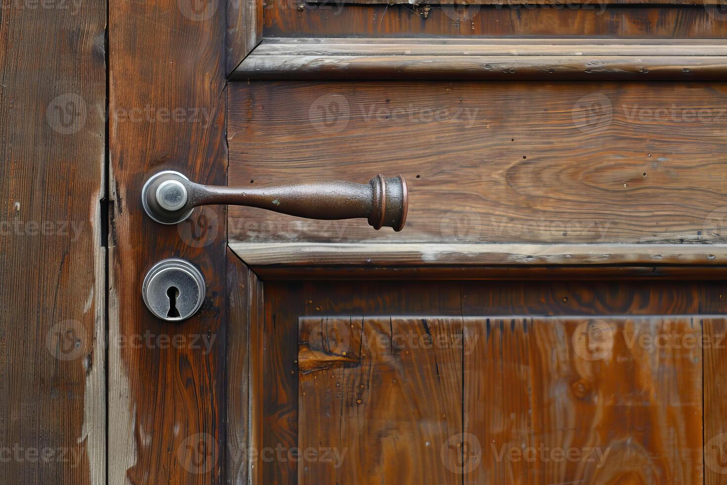 Old round door handle and keyhole on a wooden door photo
