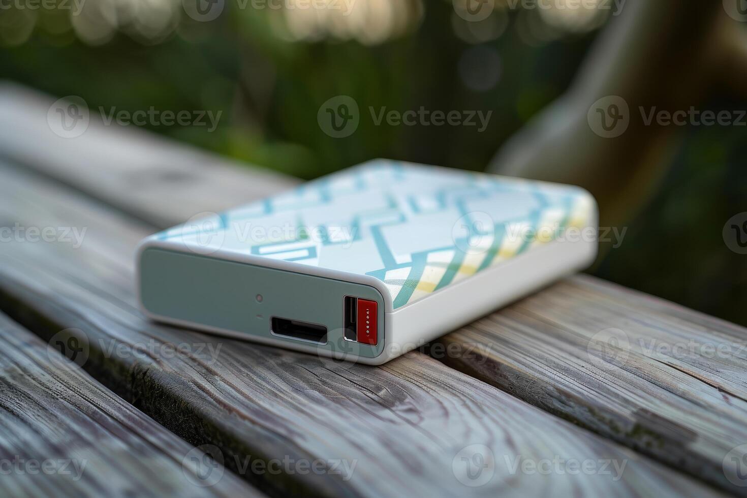 Modern external battery pack sitting on a wooden table photo
