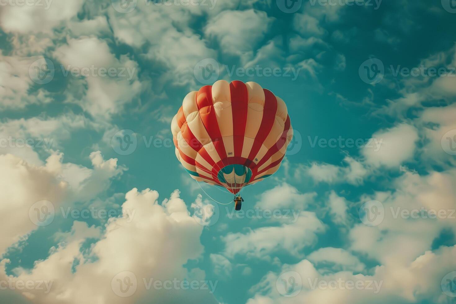 Colorful hot air balloon floating in the cloudy sky photo