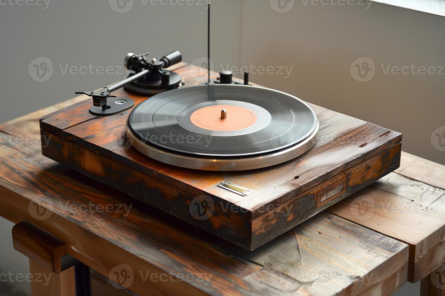 Vintage record player playing vinyl on wooden table photo