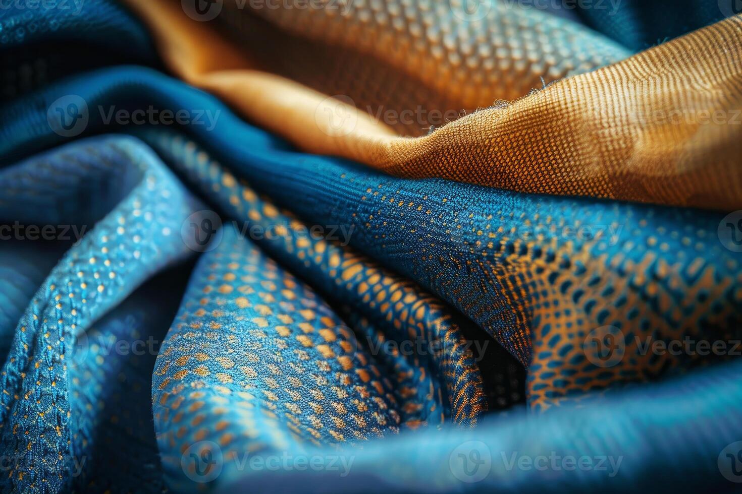 Blue and gold fabric forming elegant folds and textures photo