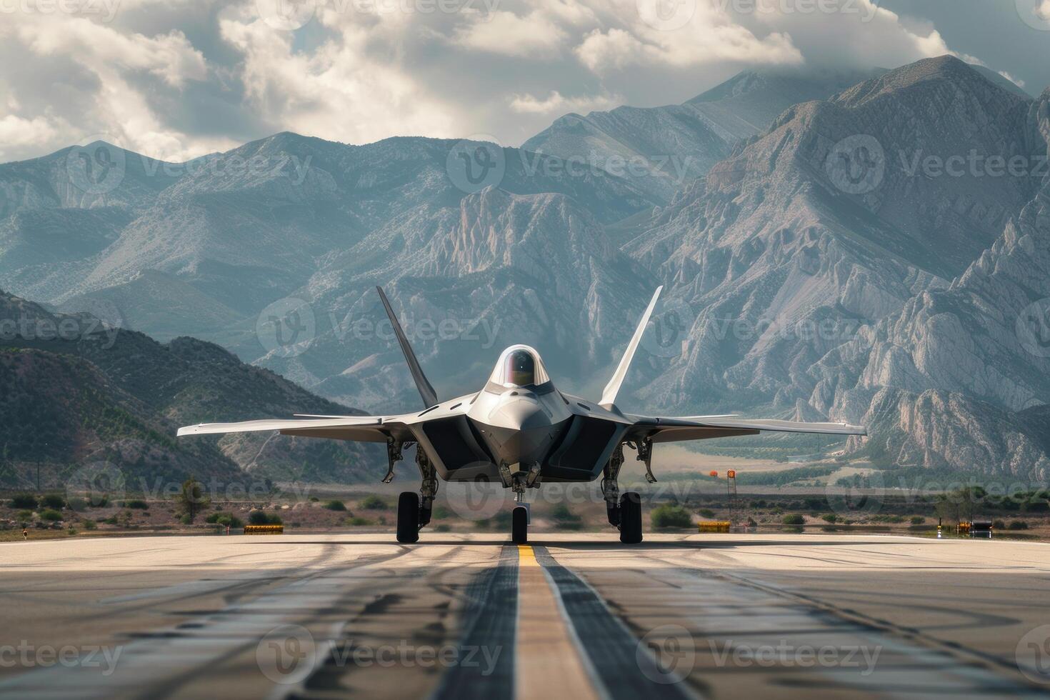 F 22 raptor standing on airfield with mountains in background photo
