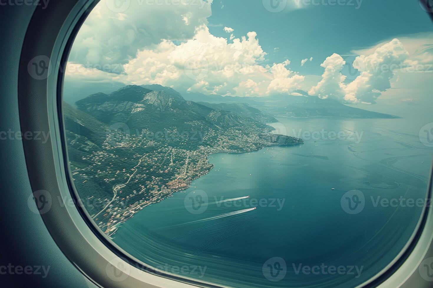 Airplane window showing amazing view of sea and mountains photo