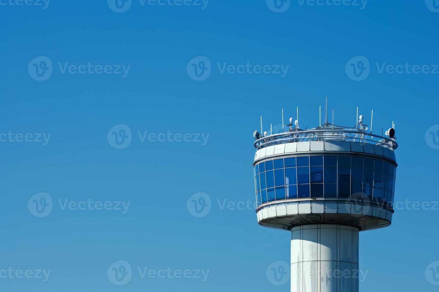 Airport control tower standing tall against clear blue sky photo