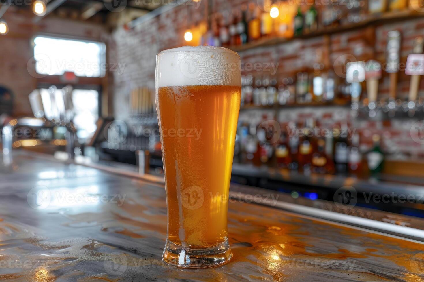 Cold glass of beer sitting on bar with bartender in background photo