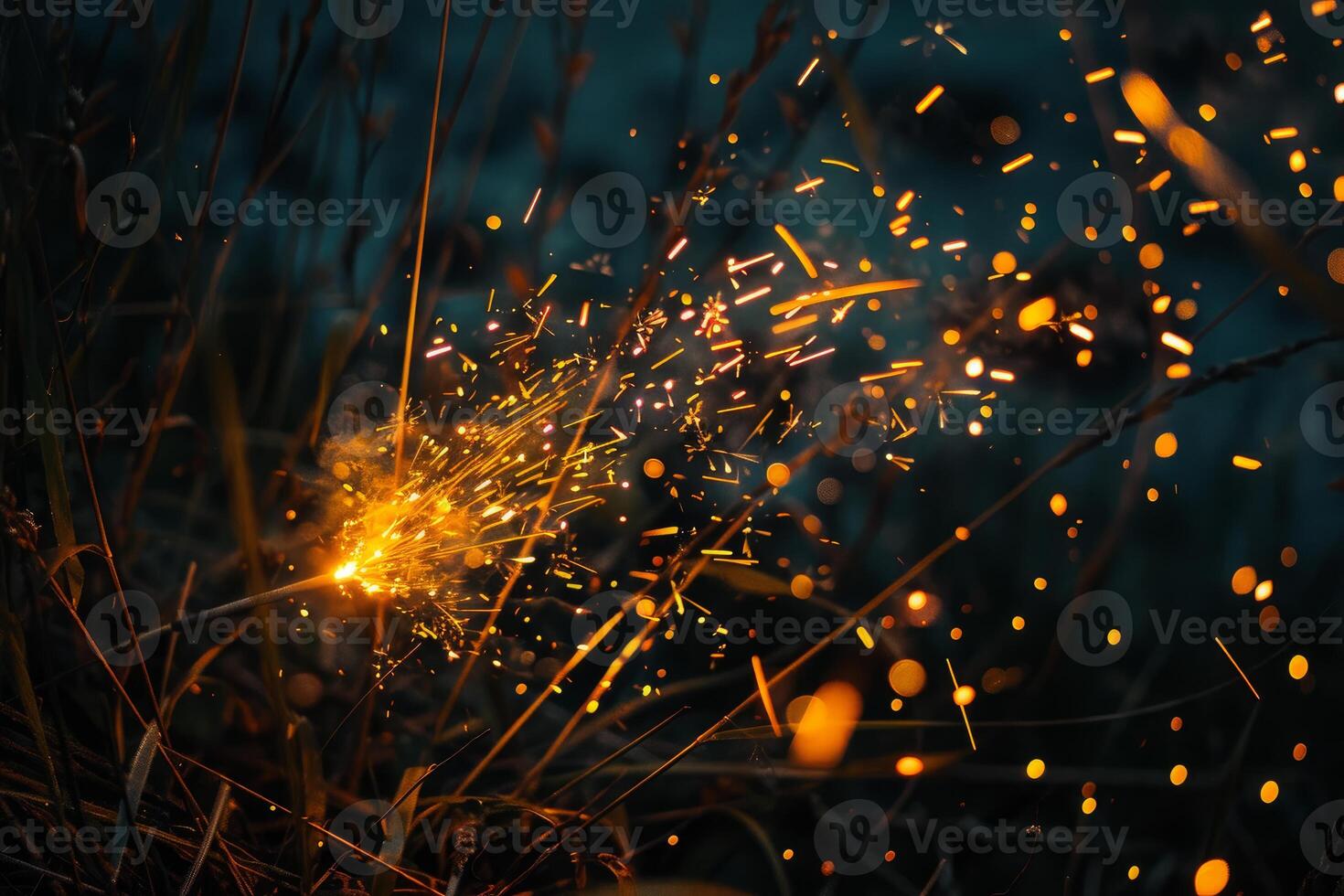 Bengal fire sparking and burning in the grass at night photo