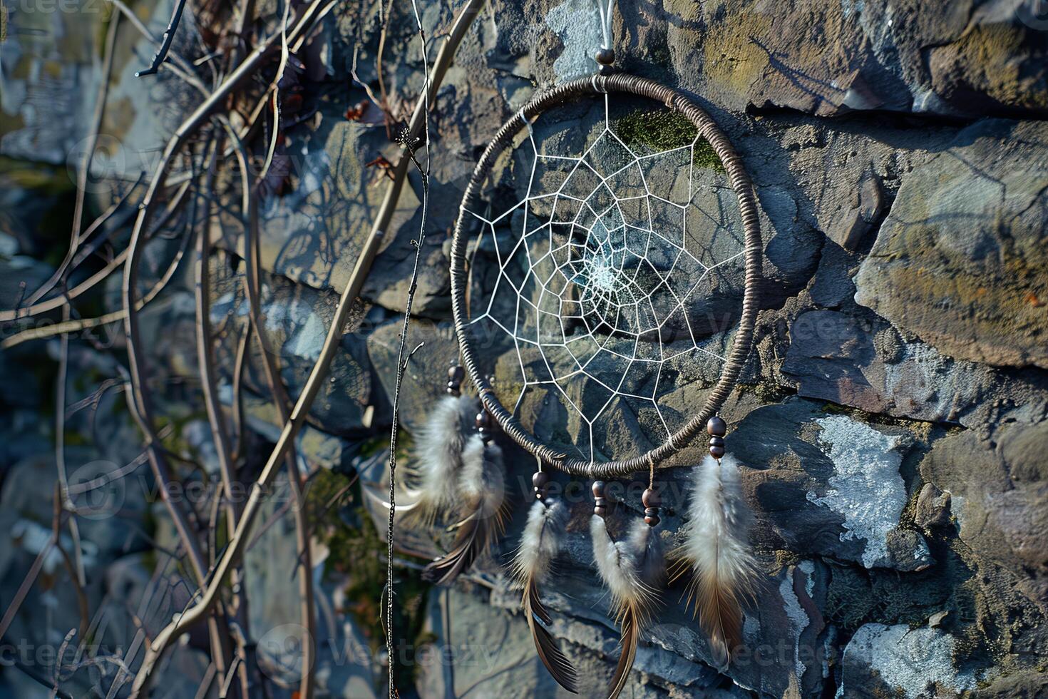 Native american dreamcatcher hanging on a stone wall protecting from bad dreams photo