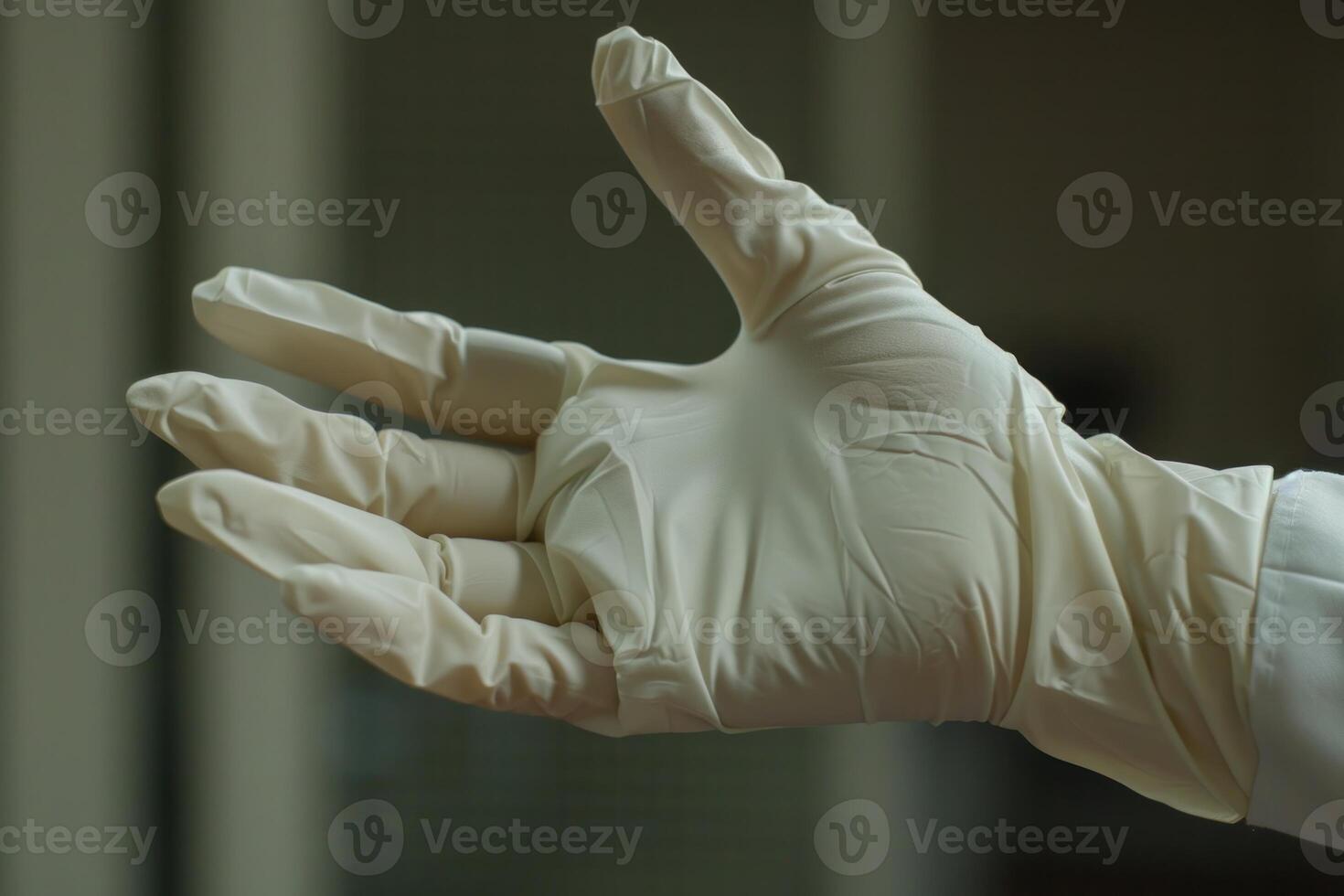 Doctor wearing a latex glove is keeping his hand open photo