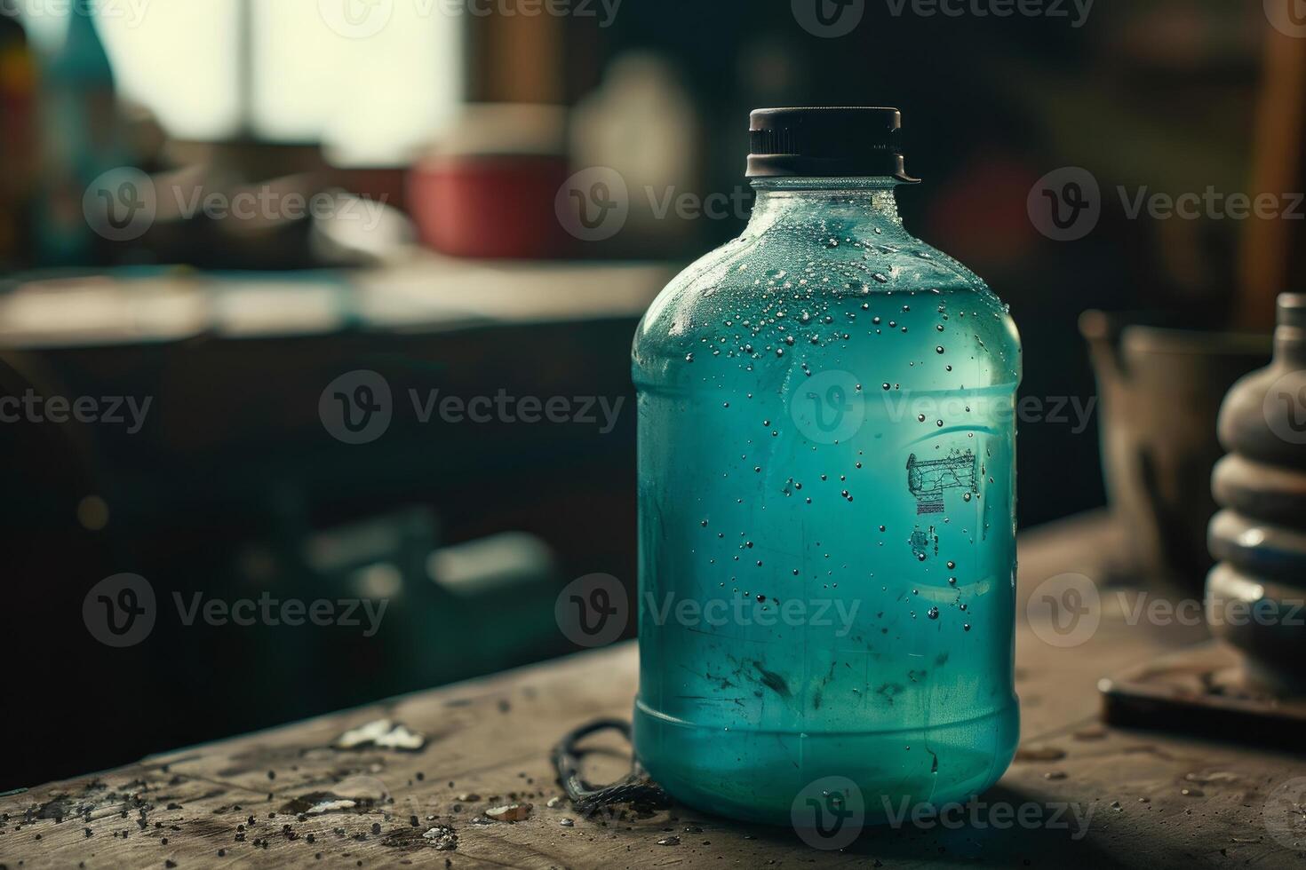 Cooling down a plastic bottle full of water is standing on a workbench in a workshop photo