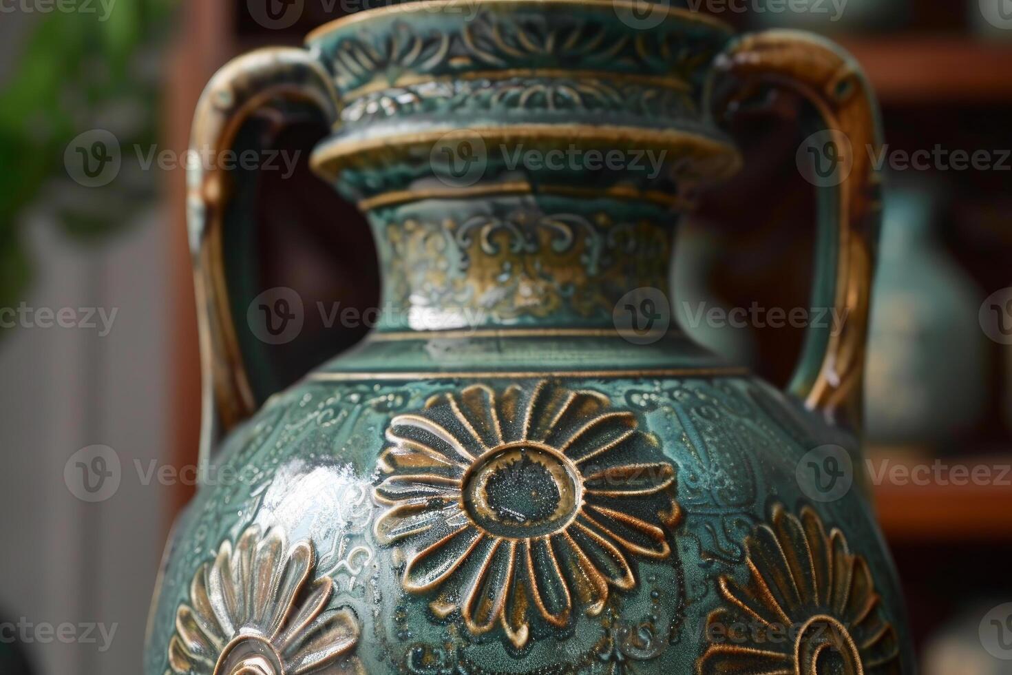 Elegant green ceramic vase with floral relief detailing standing on a wooden shelf photo