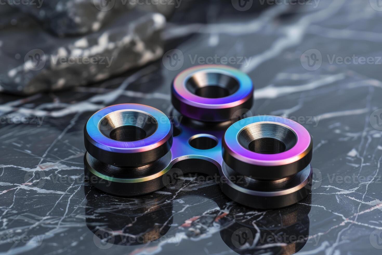 Modern fidget spinner resting on marble surface photo