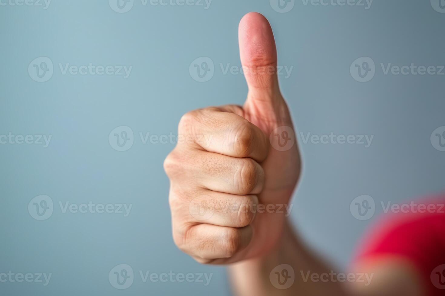 Man showing thumbs up gesture on blue background photo