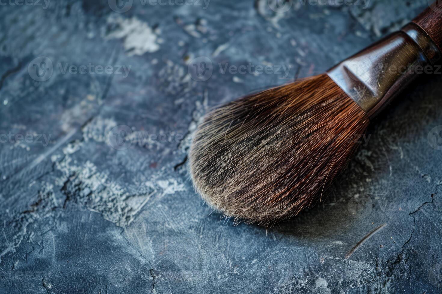 Large used makeup brush resting on gray countertop photo