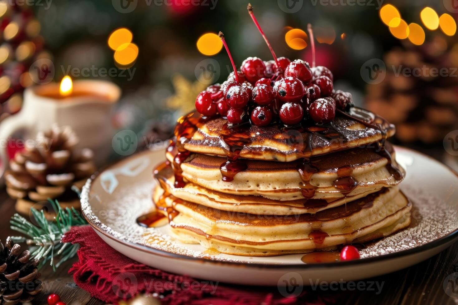 Delicious christmas pancakes drizzled with maple syrup and topped with red currants photo
