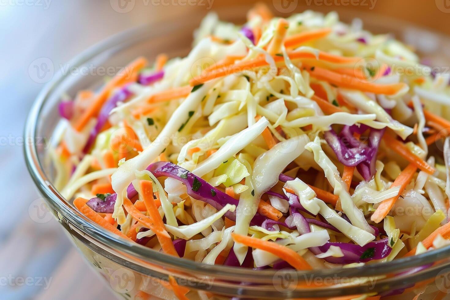 Freshly made coleslaw salad is served in a glass bowl photo