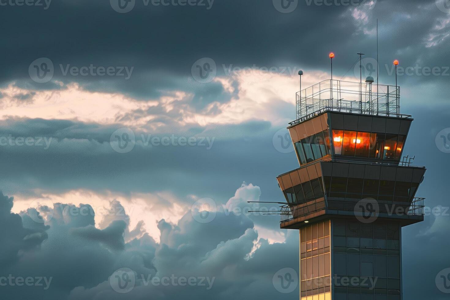 Airport control tower standing tall against stormy sky photo