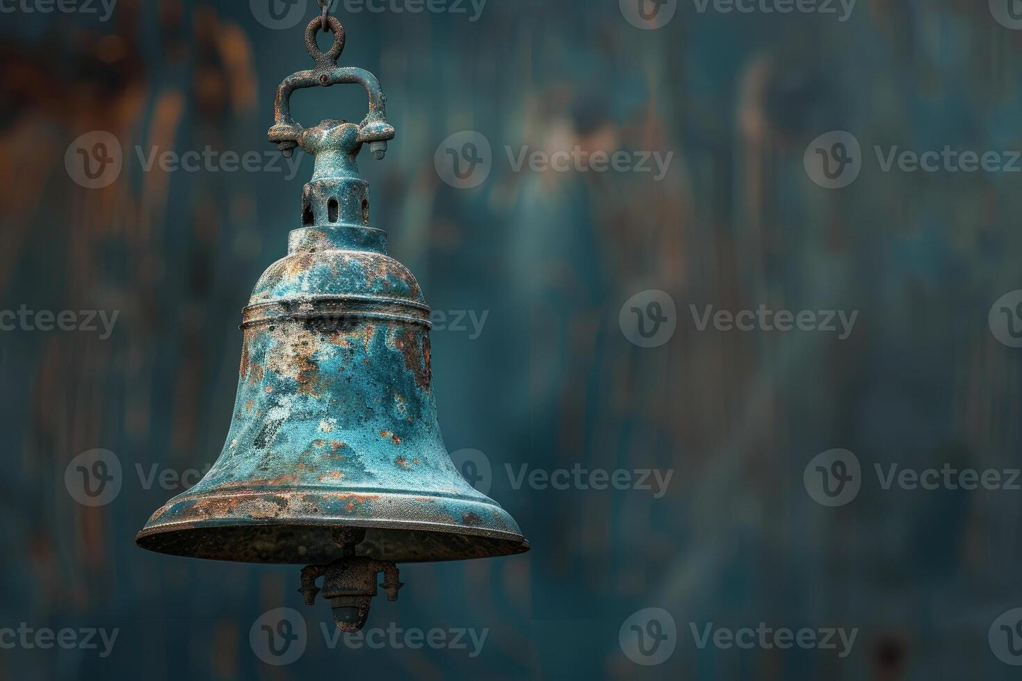 Old rusty metal bell hanging with blurred background photo