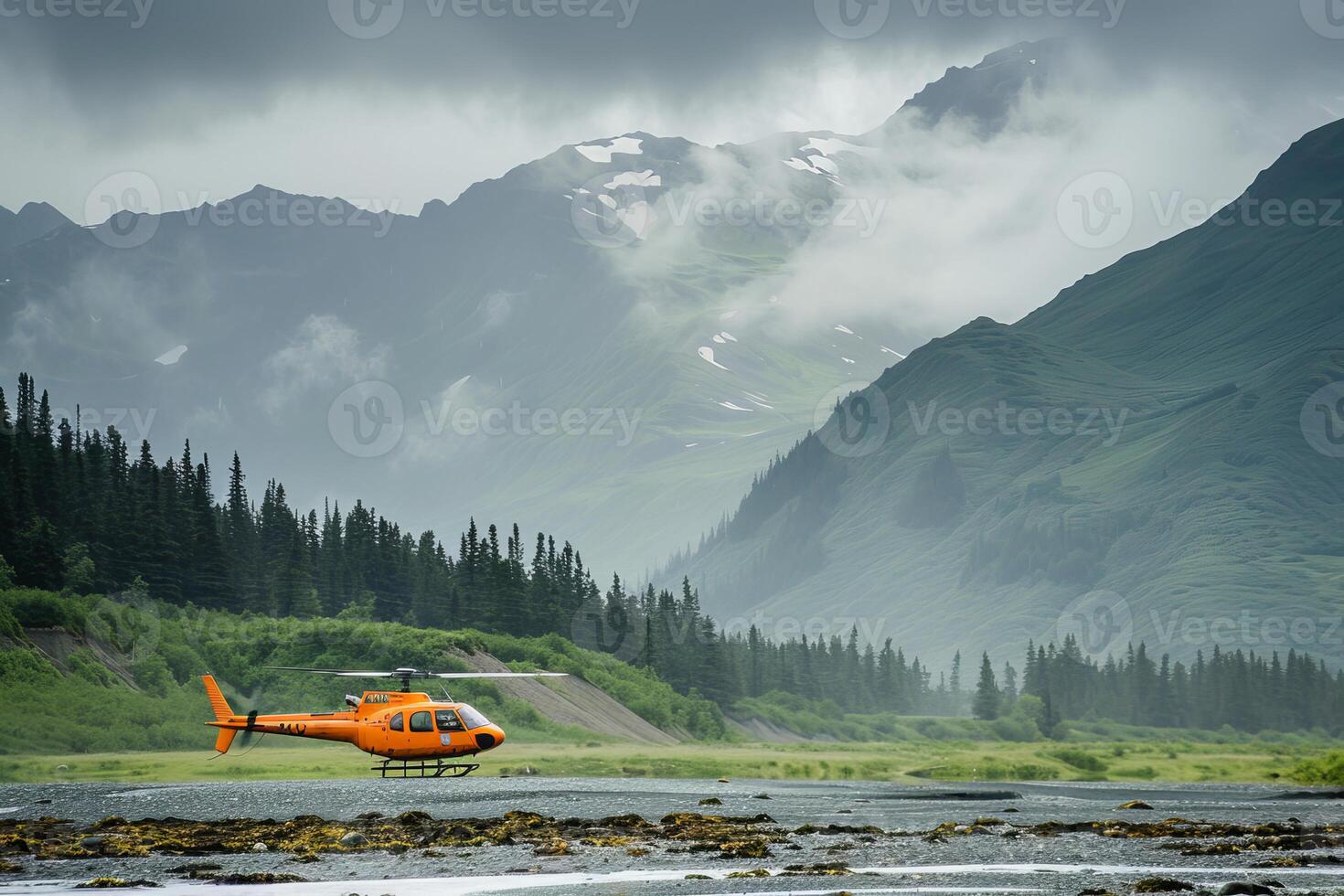 Orange helicopter taking off from alaskan wilderness with mountain in background photo