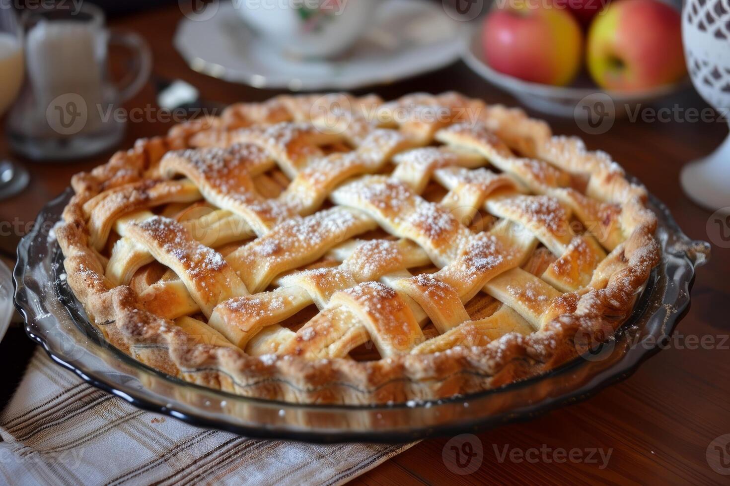 Freshly baked apple pie with a lattice crust dusted with powdered sugar photo