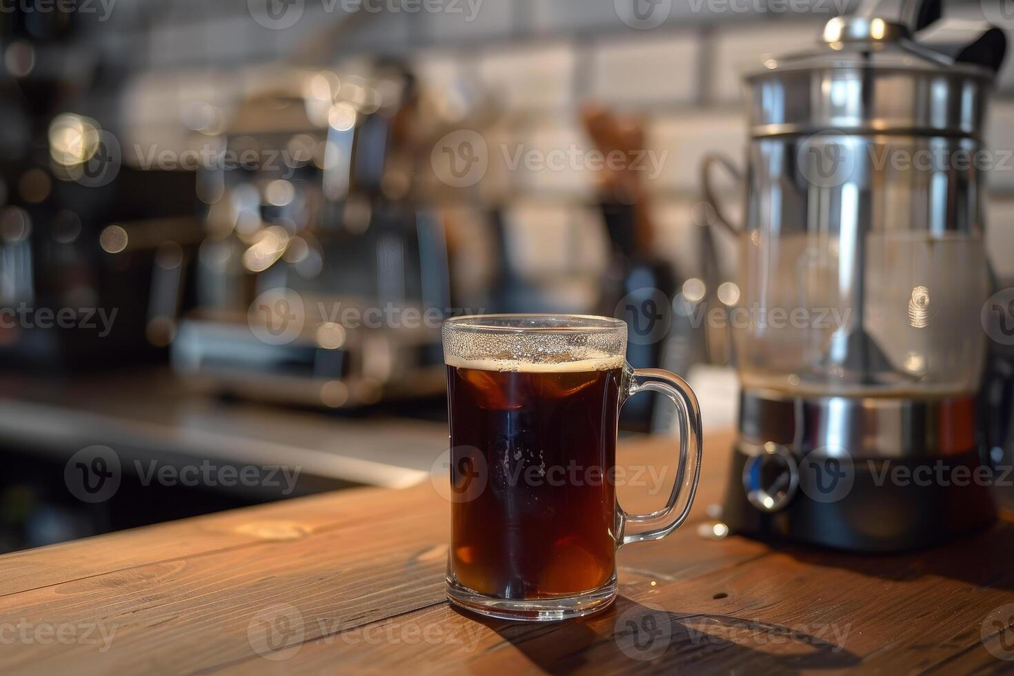 Refreshing glass of iced coffee sitting on wooden countertop in coffee house photo