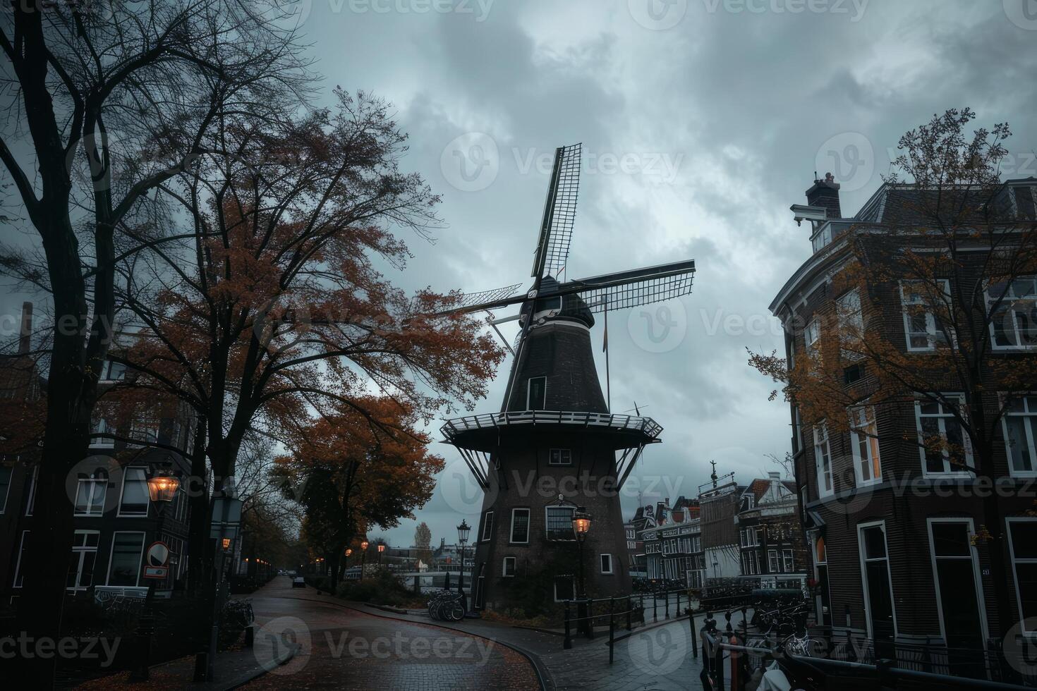 Traditional dutch windmill standing tall on a cloudy autumn day in the city photo