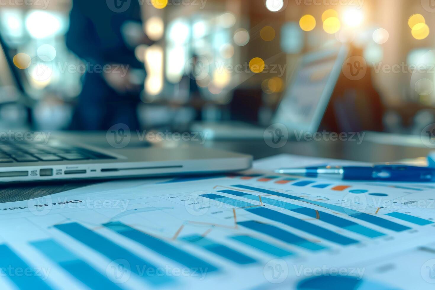 Business team analyzing financial charts and graphs using laptop photo
