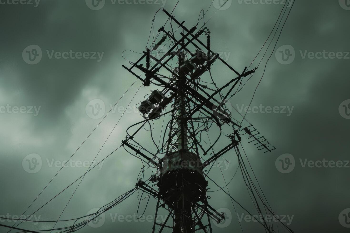 Dark and ominous utility pole looming over a stormy sky photo