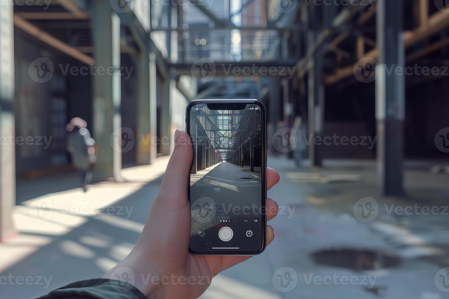 Tourist taking photo of industrial building with smartphone