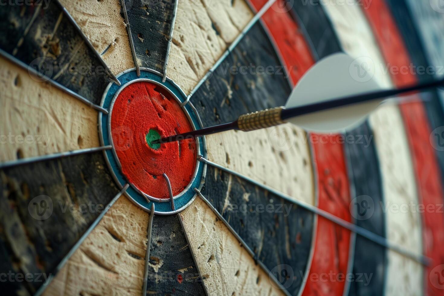 Dart hitting a target on dartboard showing concept of success photo