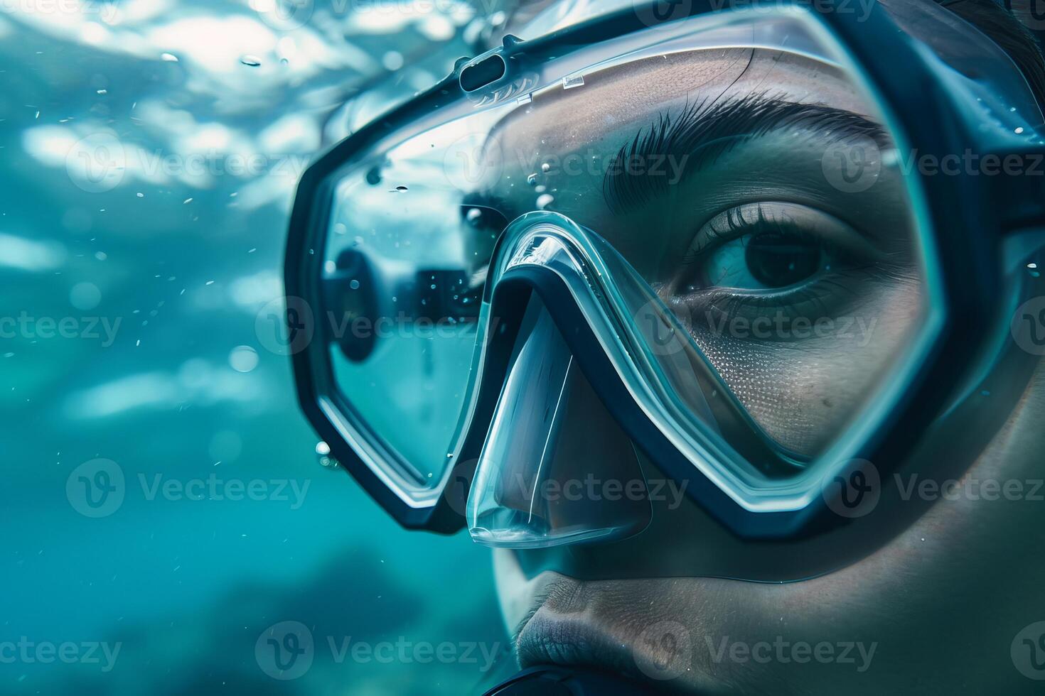 Young woman is scuba diving in blue ocean water photo