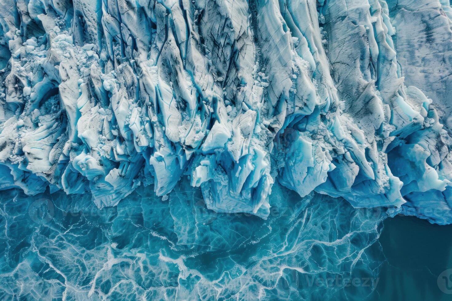 Glacier ice melting in ocean creating abstract shapes and textures photo