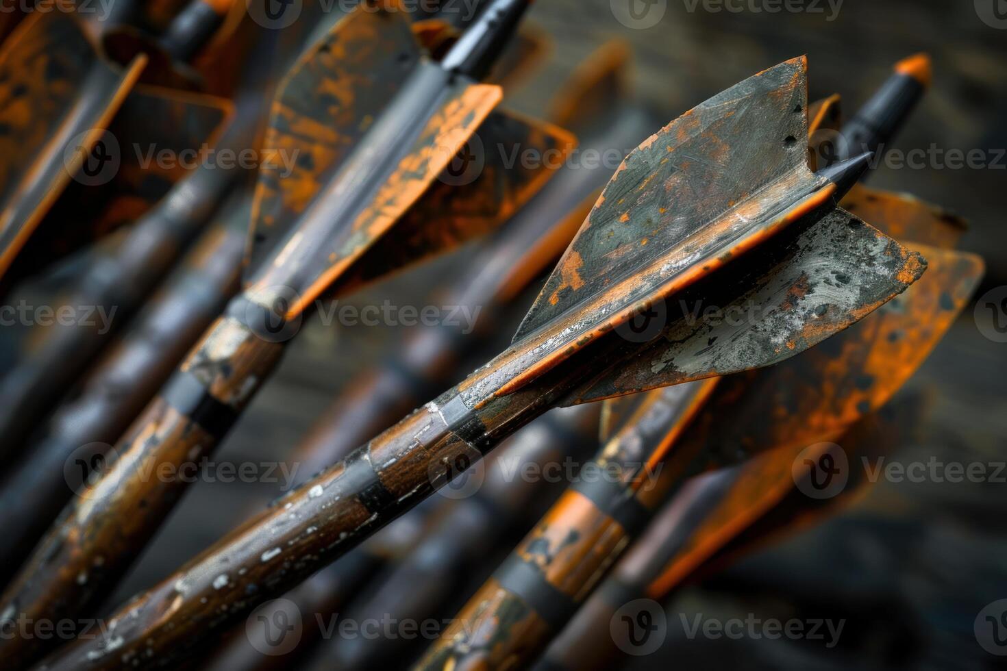 Close up of old weathered wooden arrows with orange fletching photo