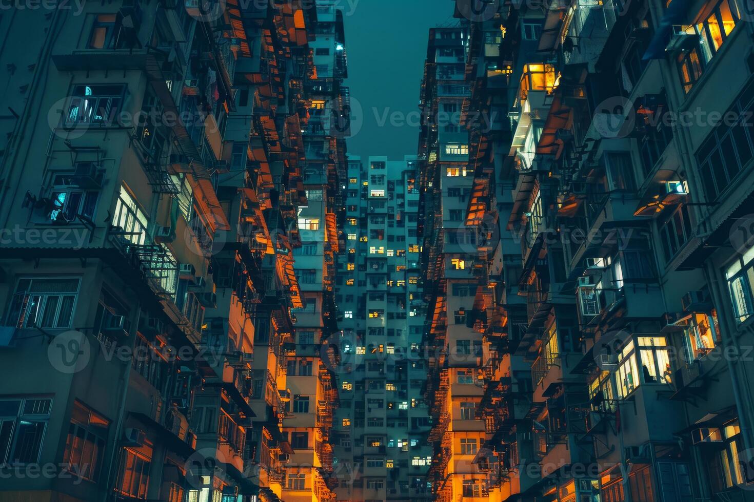 Narrow street running between crowded hong kong buildings at night photo