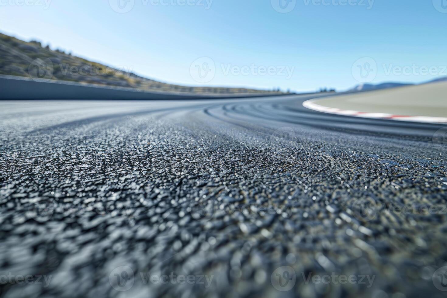 Empty race track winding through mountain landscape photo