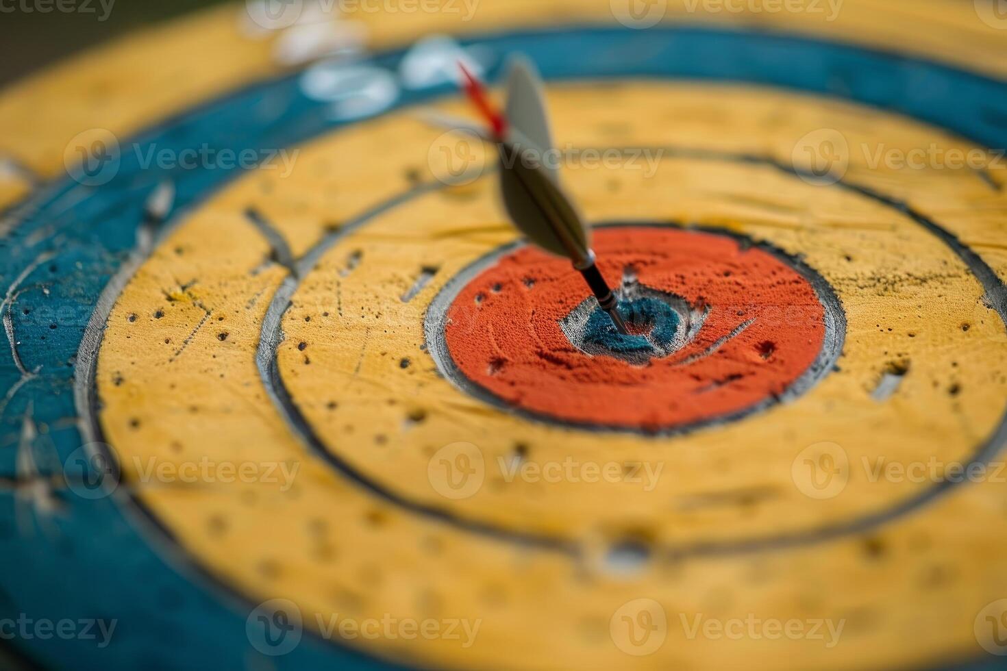 Dart striking the center of an archery target photo