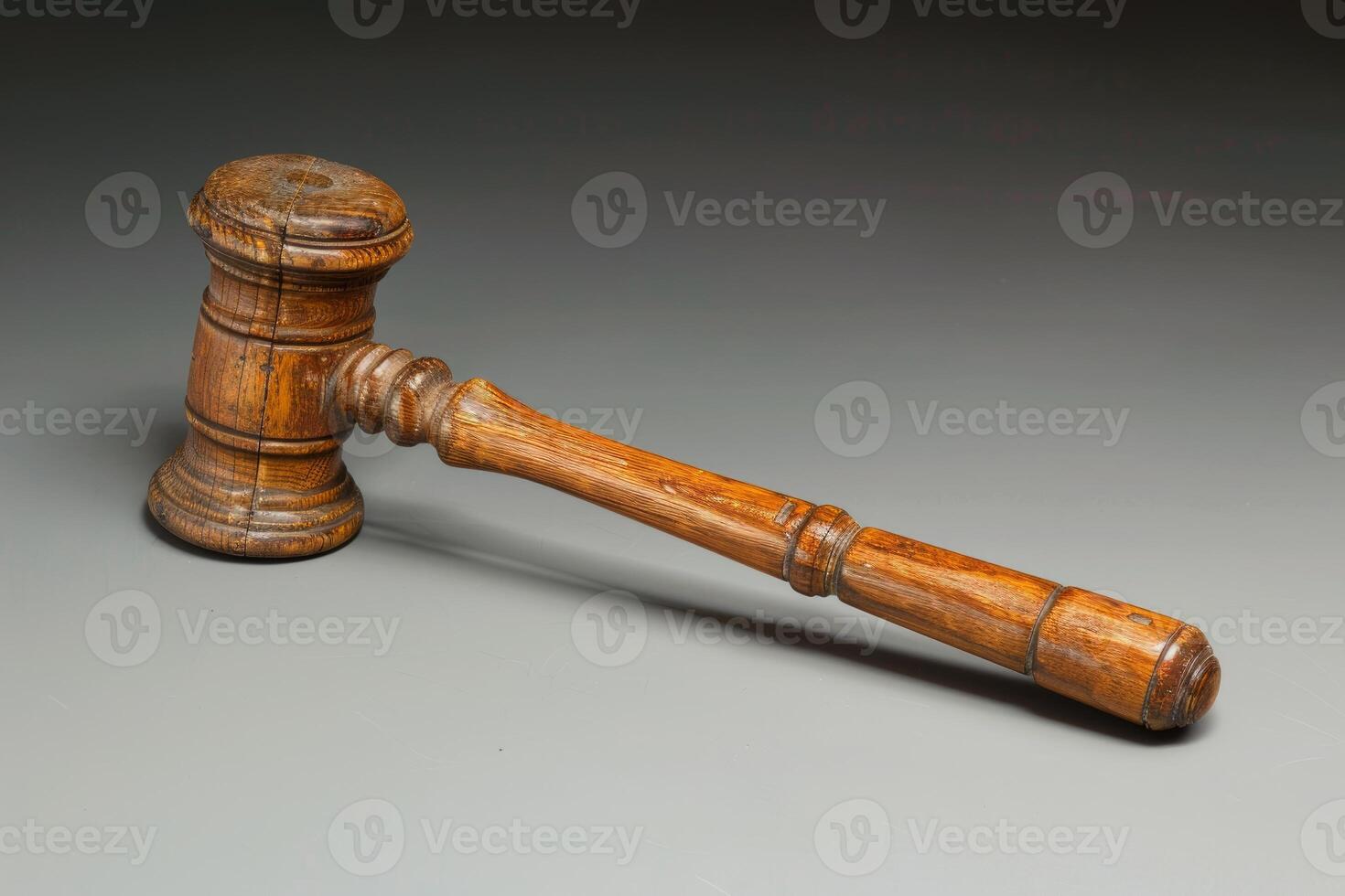 Wooden gavel lying on a gray surface symbolizing justice photo