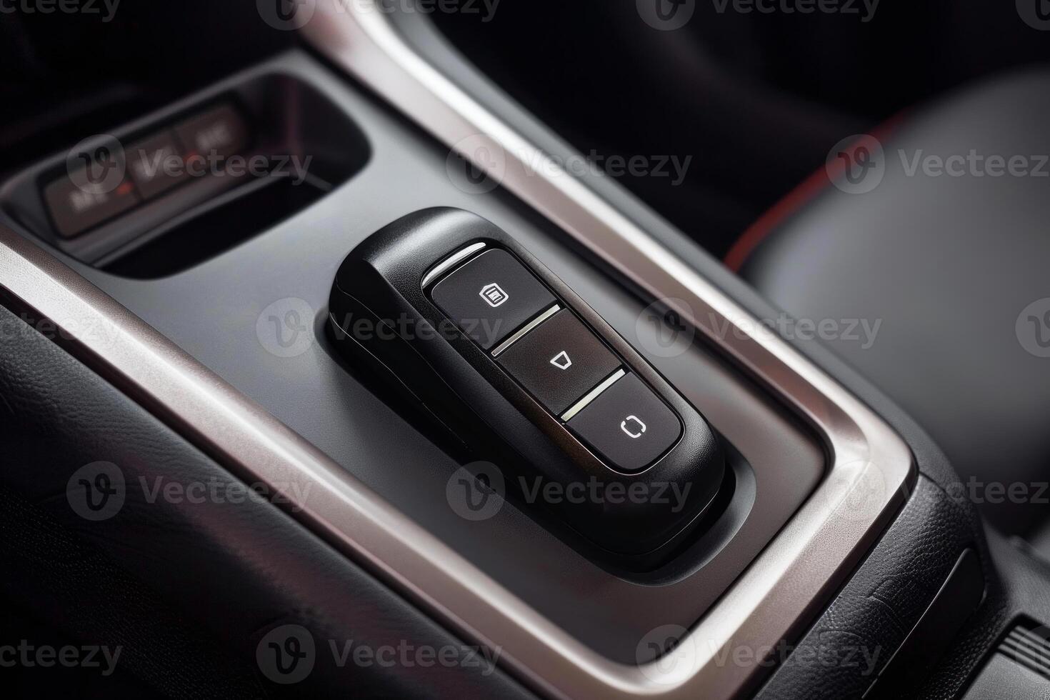 Modern car key remote control lying in a car center console photo