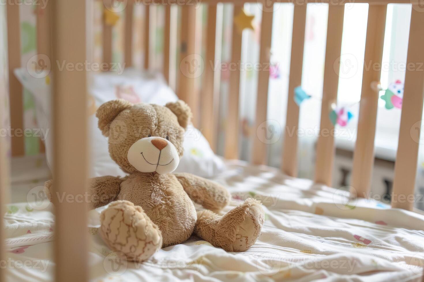 Teddy bear sitting in empty baby crib photo