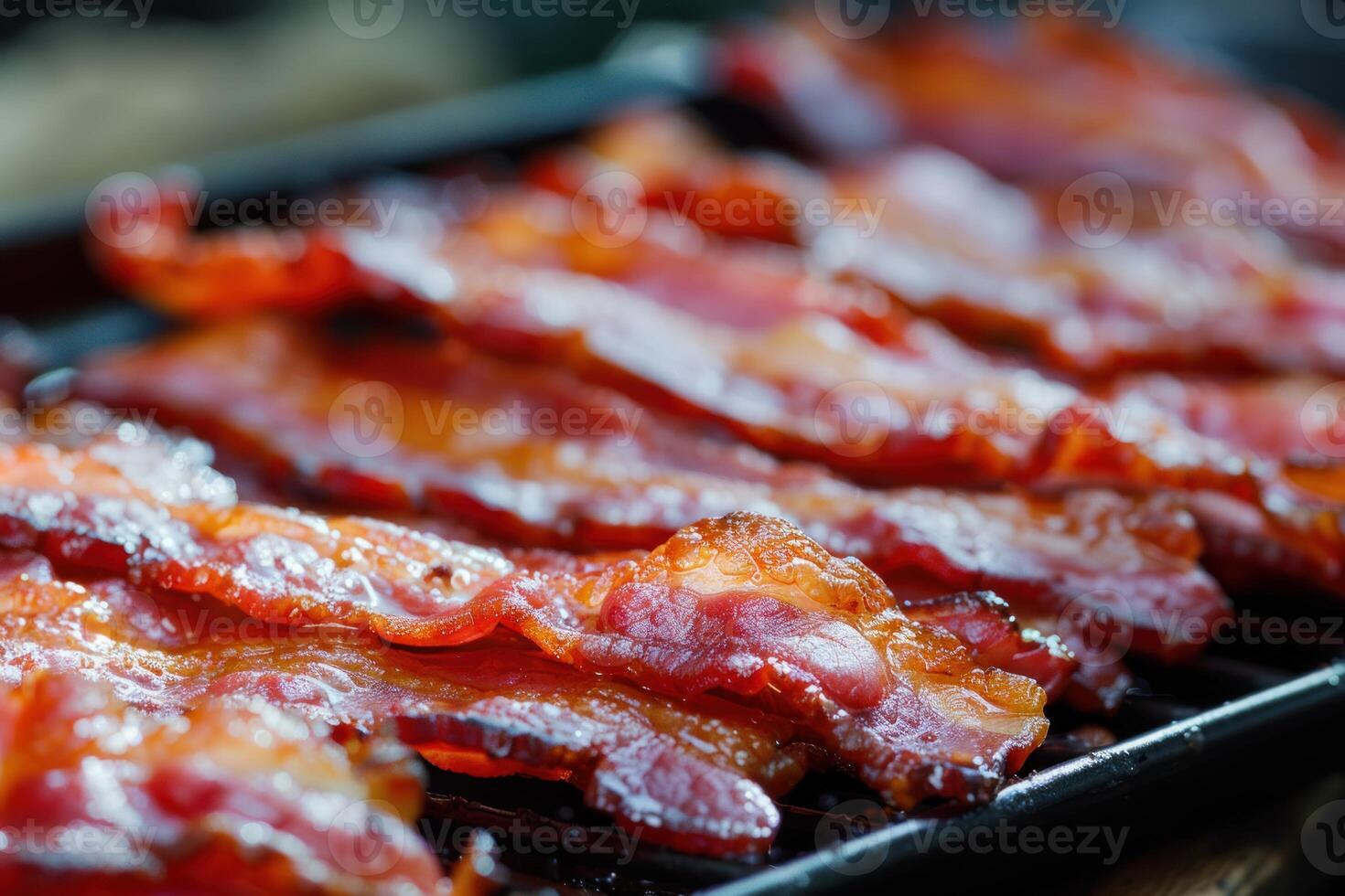 Delicious crispy bacon cooking on a baking sheet photo