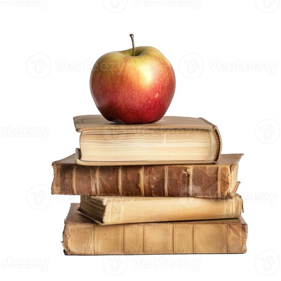 Red apple resting on stack of old books isolated on white background photo