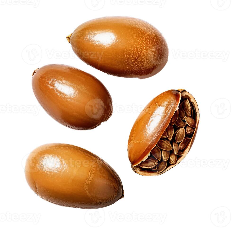 Argan nuts falling showing seeds on white background photo