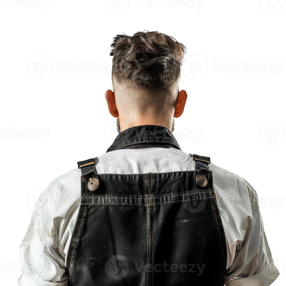 Construction worker wearing black overalls standing back to camera photo