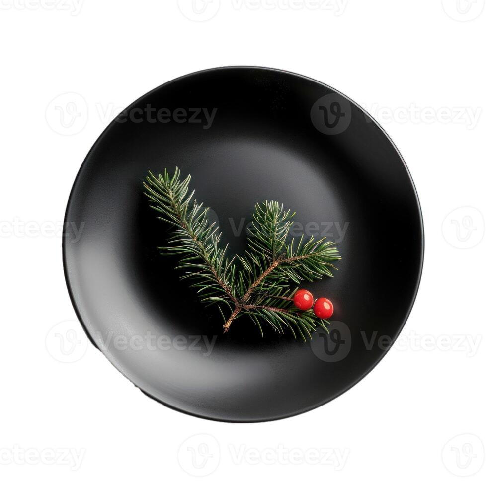 Christmas table decoration idea with evergreen spruce branch and red berries on black plate photo