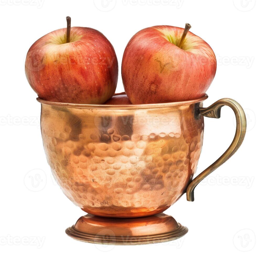 Two red apples resting in an antique copper cup photo