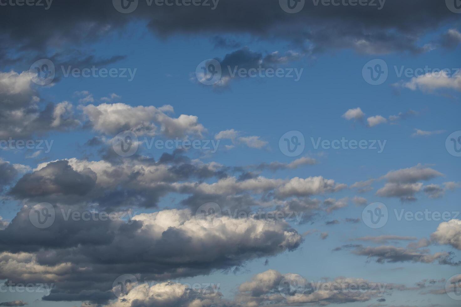 Dramatic sky with dark, light clouds against bright blue backdrop, capturing the essence of weather photo