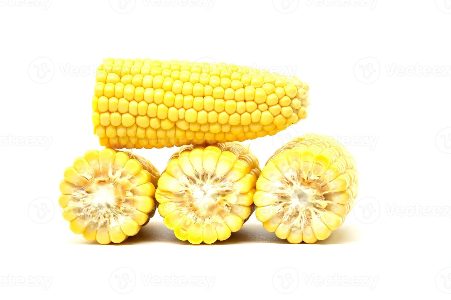 Close-up image of fresh corn cobs arranged on a white background photo