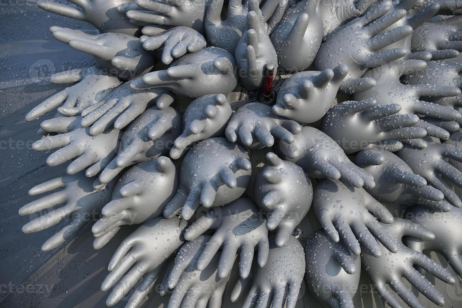 Abstract composition of inflated rubber gloves with water droplets creating unique artistic pattern photo