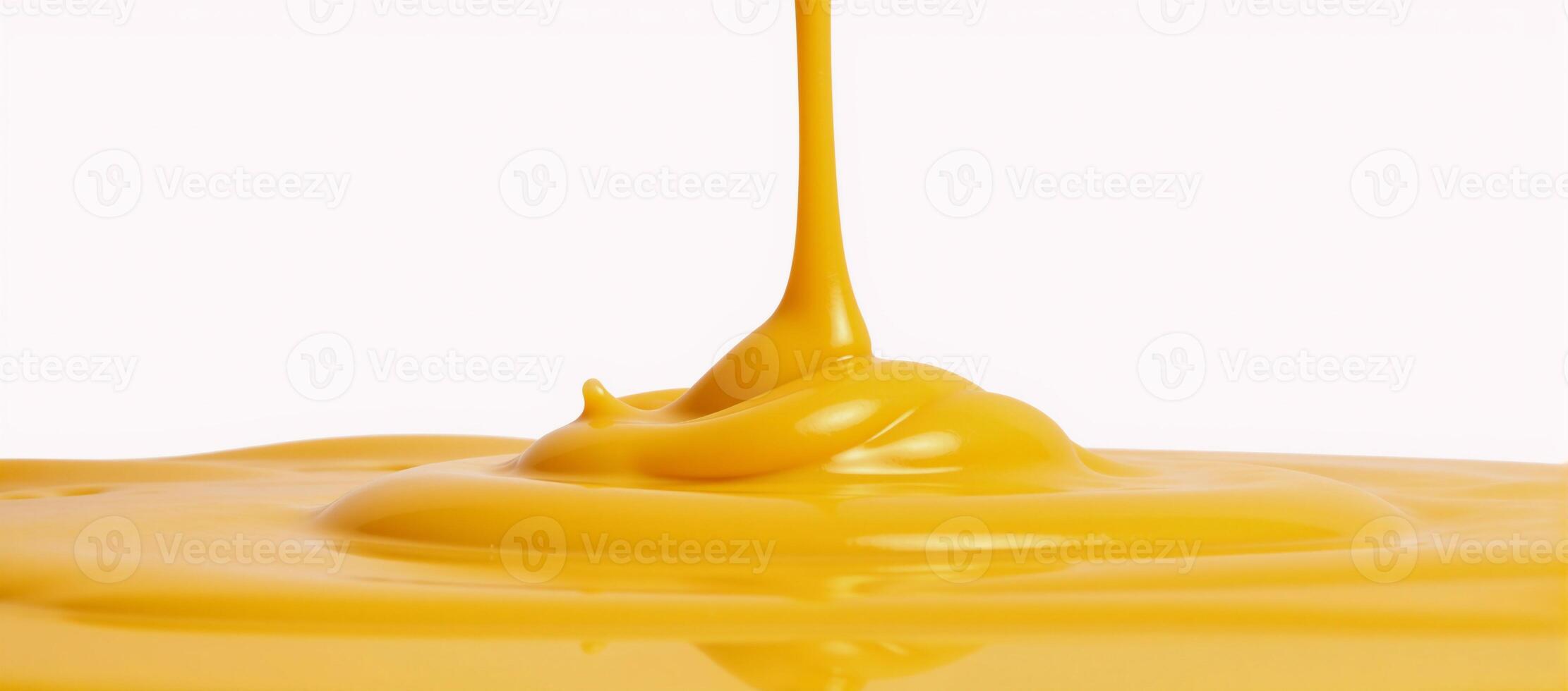 Melted cheese sauce spills onto a pristine white backdrop photo