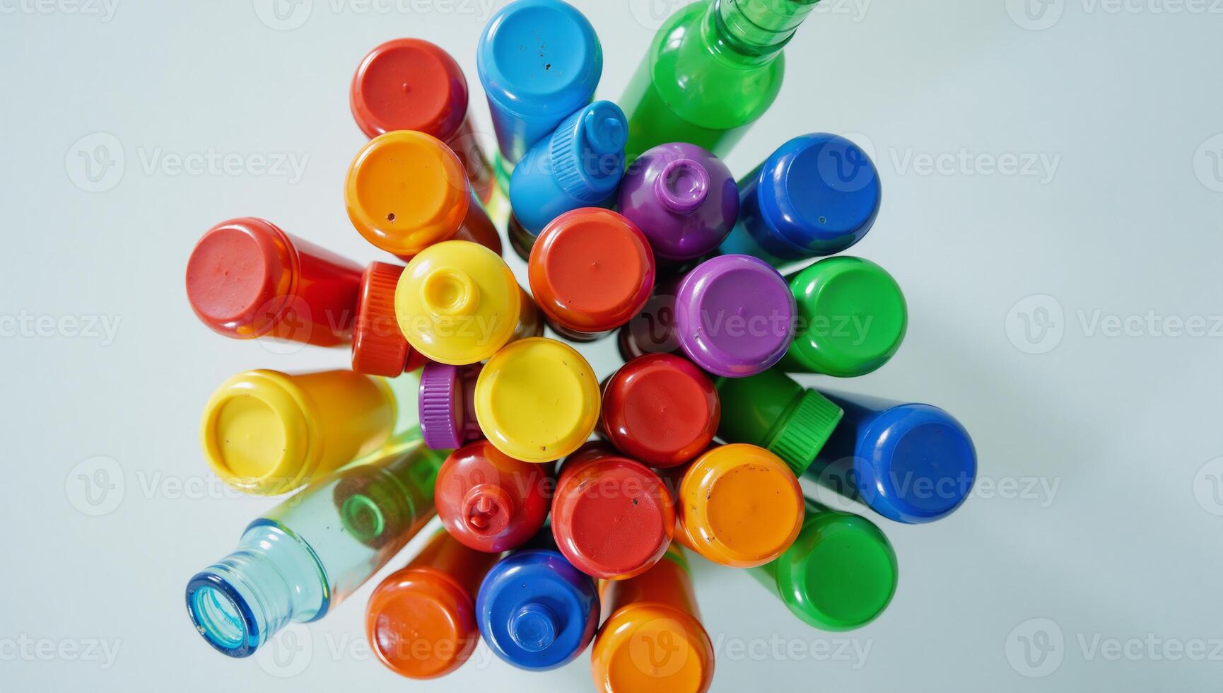 A collection of assorted colored plastic bottle tops and containers photo