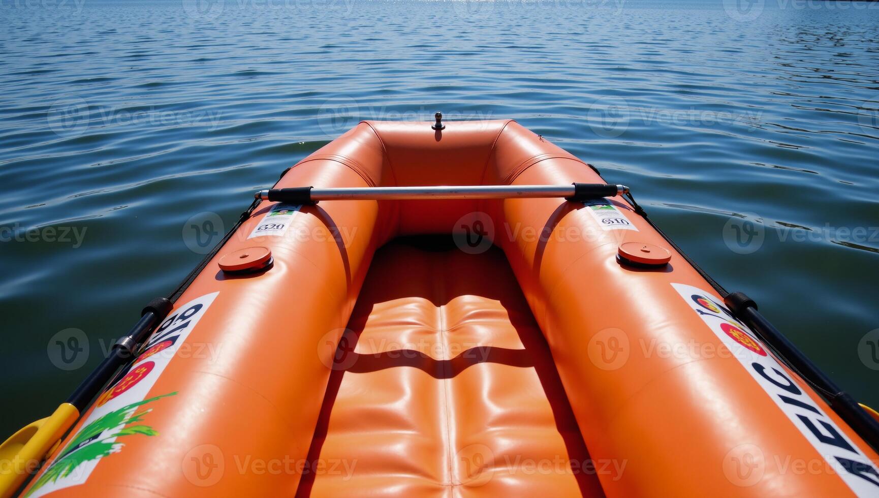 Orange inflatable raft with oars intended for water sports photo